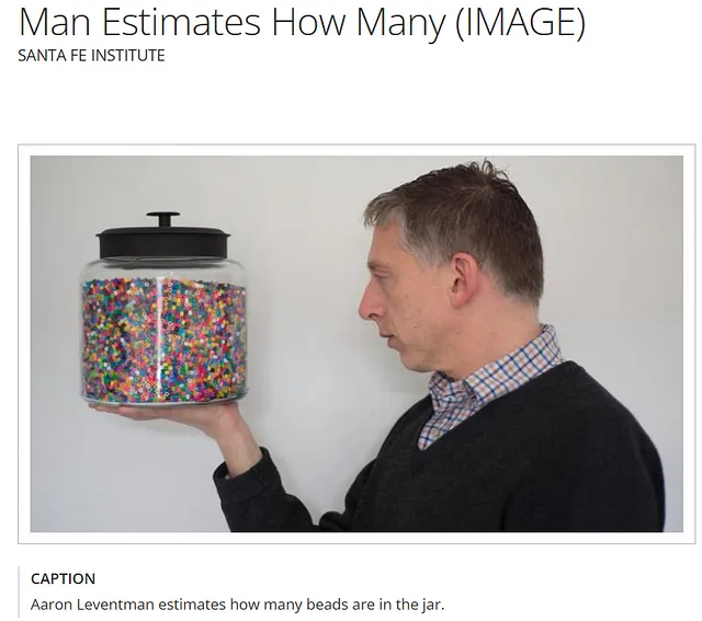 a man holding a jar of beads